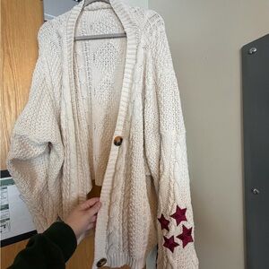 Taylor Swift Cream Cardigan with Red Star Details